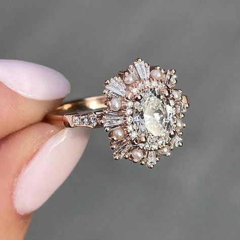 Custom Order For Melissa: 1.25CT Oval Moissanite Cluster Baguettes & Pearls Halo Moissanite Engagement Ring In 14K Solid Rose Gold By Moaana Jewel ♦ Stone: Moissanite ♦ Shape: Oval Cut ♦ Color: Colorless ♦ Main Stone Weight: 1.25 Carat  ♦ Main Stone Diameter: 8x6 mm  ♦ Side Stones: 0.59 CTW Round & Tapered Baguette Cut ♦ Side Stone Type: Created Pearls & Moissanite ♦ Clarity: VVS ♦ Crown Style: Halo/Double Halo ♦ Metal: 14K Solid Gold ♦ Metal Finish: Rose Gold ♦ Note: Plain Band ♦ Nickle Free ♦ Heidi Gibson, Halo Moissanite Engagement Ring, Cute Engagement Rings, Future Engagement Rings, Oval Moissanite, Plain Bands, Dream Engagement, Dream Engagement Rings, Double Halo