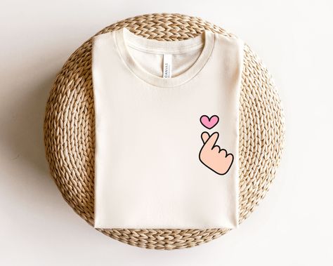 Korean Heart Sign Shirt, Valentines Day Gift For Kdrama Lover UNISEX T-Shirt Bella+Canvas 3001 .: 100% cotton .: Light fabric (4.2 oz/yd² (142 g/m .: Runs true to size ❤️ Returns & exchanges I don't accept returns, exchanges, or cancellations All sales are final. Thank you for supporting our small business! Valentine Tshirt Ideas, Korean Heart Sign, Korean Heart, Shirt Korean, Korean Design, Valentine T Shirts, K Drama, Heart Sign, Logo Ideas