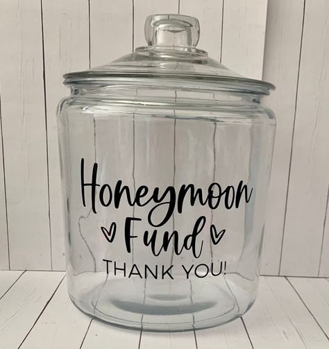 Honeymoon Fund Jar Decal, Wedding Shower Decal, Honeymoon Decal, Anniversary decal, Piggy Bank decal stickers, Travel decal, coin jar decal  Planning your honeymoon?!? Use this decal to put on a container to display at your wedding reception or wedding shower for your loved ones to help donate. Jar is not included.  This decal will say honeymoon fund thank you and come with hearts.  Message me the color vinyl decal you want. If I don't have a message with your order with color I will send black. Honeymoon Fund Jar, Honeymoon Shower, Coin Jar, Wedding Fund, Cricut Wedding, Country Theme Wedding, Honeymoon Fund, Wedding Activities, Dream Wedding Ideas Dresses