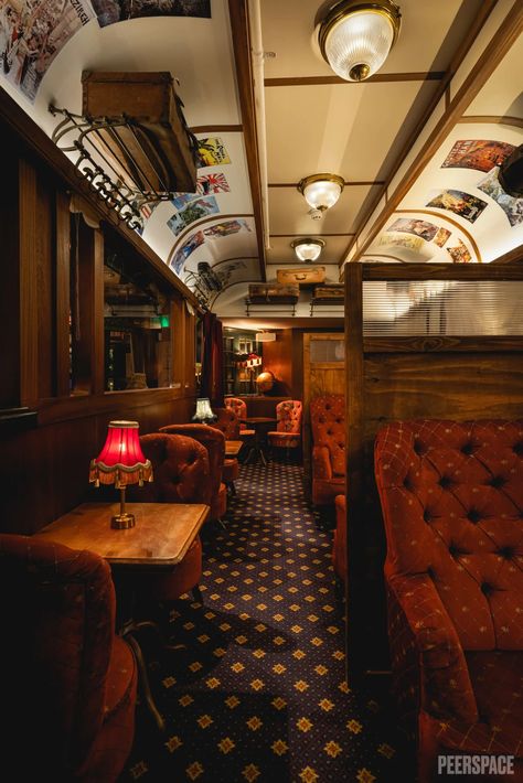 A place of exploration and adventure, this unique bar boasts wood-panelled walls, warm leather seating and shelves laden with eccentric artifacts. Alongside the bar lies the life-size model of a Victorian train carriage, perfect for seated and standing events and complete with banquette seating, brass lamps and windows overlooking the bar area. This Classic Victorian theme bar is the perfect spot for your next event. Train Seat, Scifi Interior, Luxury Train, Old Train, Banquette Seating, Bar Areas, Brass Lamp, Covent Garden, Cocktail Bar