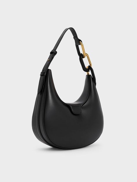 This Kora moon bag in black will easily become one of your favourite bags in your collection. First, in black, it will become a timeless piece which you can use for any occasion. The smooth moon silhouette will add stylish structure, making it the perfect piece to play up your outfit with proportions. Plus points for the chunky chain accents that add subtle shine and a distinctive touch that will elevate any look. With magnetic flaps that keep your belongings easily accessible yet secure, you will be able to carry this around all-day with ease. Moon Silhouette, Moon Bag, Charles Keith, Metallic Accents, Timeless Pieces, Moon, Chain, Handbags, Black