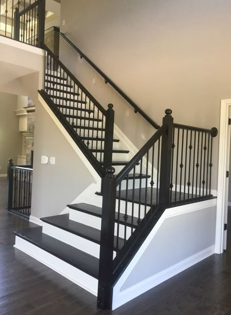 Black Banister With Iron Spindles, Banister Spindles Ideas, Stair Casing Ideas, Espresso Stained Stairs, Wrought Iron Spindles On Stairs, Black And White Staircase, Foyer Decor Ideas, Wrought Iron Stair Spindles, Foyer Design Ideas