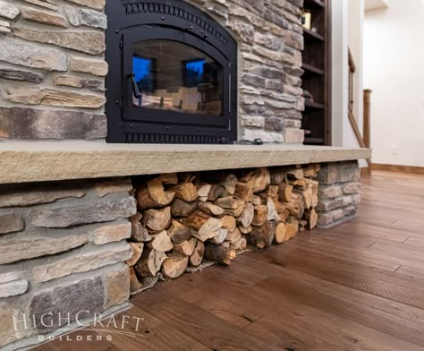 As Haley mentioned in Part 1, “We’re swimming in firewood,” and they use a wood-burning fireplace insert to help heat their home. Below the fireplace, a clever wood storage solution was created under the stone hearth. Firewood Storage Under Fireplace, Wood Stove Surround With Wood Storage, Living Room Wood Burning Fireplace, Wood Burn Fireplace, Wood Storage Under Wood Stove, Woodburner Fireplace Insert, Wood Burning Fireplace Hearth Ideas, Wood Burning Stone Fireplaces, Brick Fireplace With Log Storage