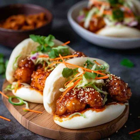 Soft and fluffy Korean Chicken Bao Buns are the fusion of the delightful crispy and savory goodness of Korean fried chicken combined with the comforting embrace of steamed bao buns. So what makes Crispy Fried Chicken Bao Buns so irresistible? Korean Chicken Bao never fails to impress when I prepare them. Korean Fried Chicken Bao Bun, Fried Chicken Bao Buns, Korean Bao Buns, Chicken Bao Buns Recipe, Korean Fried Chicken Bao, Chicken Bao Buns, Bao Recipe, Steamed Bao Buns, Steamed Bao