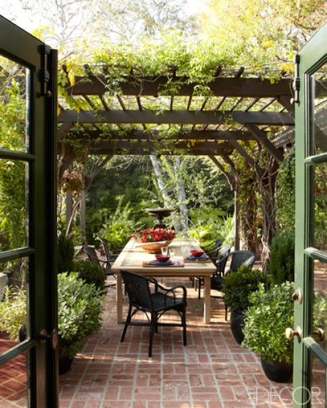 Chairs from Maison Midi surround an elm dining table beneath the pergola at a Hollywood home.  Tour the entire home.   - ELLEDecor.com Relaxing Outdoor Spaces, Terrasse Design, Brick Patios, Pergola Plans, Table Chairs, Pergola Patio, Outdoor Dining Area, Outdoor Rooms, Outdoor Design