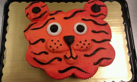 Tiger cupcake cake Tiger Cupcake Cake, Blue And Gold Cake Ideas, Blue And Gold Cupcakes, Tiger Cakes, Auburn Cake, Gold Cake Ideas, Blue And Gold Cake, Tiger Cupcakes, Cub Scout Cake