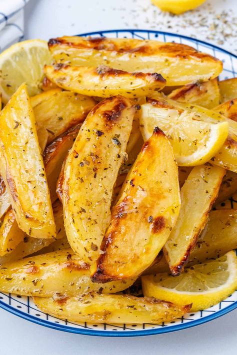 These Greek Lemon Potatoes aren't your regular potatoes. Roasted in a lemony broth, they're soft and tender with crispy edges. This is a side dish to impress! Greek Lemon Potatoes Recipes, Best Greek Potatoes Recipe, Greek Style Lemon Roasted Potatoes, Best Greek Potatoes, Authentic Greek Potatoes, Easy Greek Potatoes Recipe, Greek Potatoes Recipe Authentic, Greek Lemon Potatoes Authentic, Greek Vegetables Side