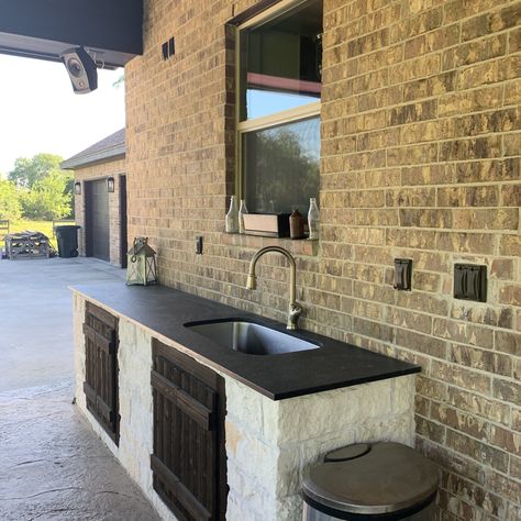 Outdoor kitchen, unpolished black granite Outdoor Kitchen Black Countertops, Black Granite Outdoor Kitchen, Black Stone Outdoor Kitchen, Leathered Granite Countertops, Leather Granite, Black Granite Countertops, Outdoor Kitchen Countertops, Porch Addition, Black Countertops