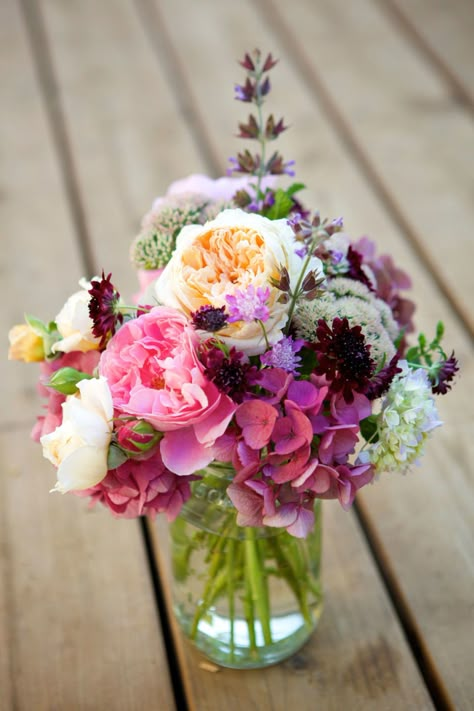 Switch off between placing bold peonies and smaller flower varieties in a clear vase for an arrangement that is loaded with texture. Flower Arrangements, Vase, Flowers