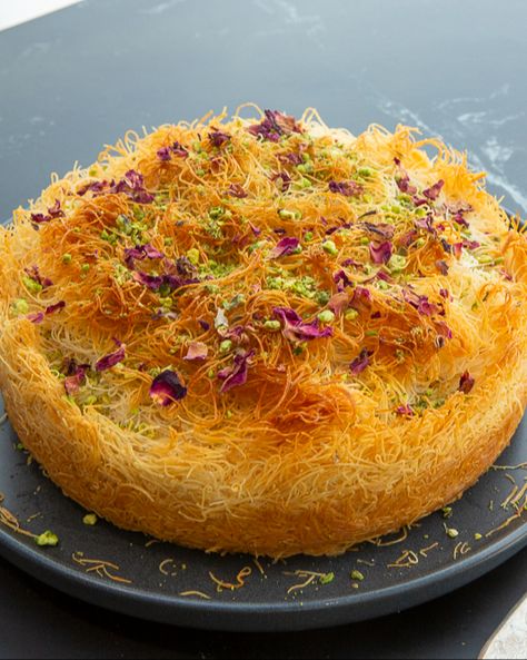 Layers of shredded pastry, creamy filling, and sweet attar syrup bring out the best of Middle Eastern flavours. This simple, yet unique dessert is perfect for festive gatherings and sure to impress! Click the link for the full recipe and wow your guests this holiday season! 🎄 Sudanese Desserts, Middle East Dessert, Dubai Recipes, Knafeh Recipe, Arab Desserts, Arabian Dessert, Lebanese Desserts Recipes, Arabian Recipes, East Dessert