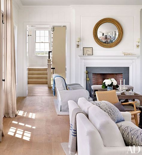 A view through the living room to the staircase in Victoria Hagan's summer home, which is decorated with light neutral colors for an airy feel. Nantucket Living Room, Nantucket Style Homes, Victoria Hagan, Nantucket Home, Nantucket Style, Bed Of Roses, American House, Mirror On The Wall, Furniture Luxury