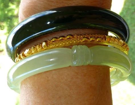 A combination of two basic Chinese jade bangle bracelets, classic green carved and deep deep almost black green with a 24k gold "spacer" bangle.  I love the yin and yang of the light translucent green jade and yang "black" jade, simple jade from the earth, with expensive 24k gold.  #13 in the travel collection. Gold Jade Jewelry, Jade Bangle Outfit, Jade And Gold Jewelry, Jade Bracelet Aesthetic, Green Jade Aesthetic, Jade Bracelet Bangles, Bangle Outfit, Clothing Aesthetics, Bracelets Outfit