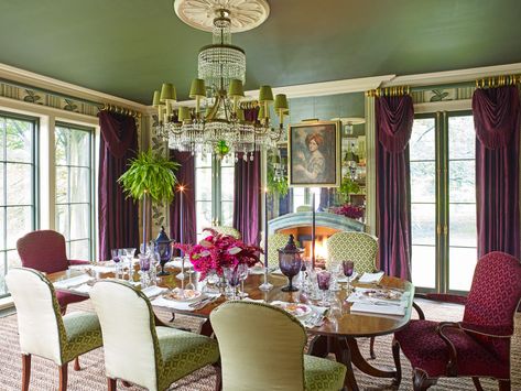 Aubergine silk curtains, velvety walls, and a dramatic Baltic chandelier invoke a sultry atmosphere made for luxurious dinner parties within this Pennsylvania home designed by Richard Keith Langham. The forest green ceiling compliments the verdant hues of a hydrangea Gracie wallpaper. The curtains are in a Schumacher silk with Passementerie bullion fringe.  The ceiling paint color is Backwoods by Benjamin Moore. Ceiling Paint Colors, Fine Paints Of Europe, Yellow Dining Room, Dining Room Paint Colors, Green Dining Room, Dining Room Paint, Dining Room Ceiling, Silk Curtains, Beautiful Dining Rooms