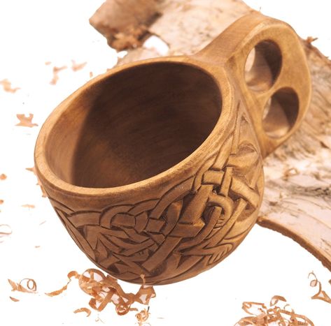 "This beautiful cup was hand-carved from linden wood. Decoration pattern is inspired by the viking founding pattern from Lisbejerg (Denmark) altar. Mugs are darkening with natural colors to achieve this warm, chocolate brown color. After polishing to make the design pop, we sealed the wood with natural oils. And here it is! Dimensions: length: 18 cm - 7\" width: 11 cm - 4\" height: 7,5 cm - 3\" Capacity 10 oz Attention : cold drinks only - i don`t respond for using with hot drinks!" Whittle Projects, Wooden Carving Design, Elvish Design, Viking Bar, Viking Wood Carving, Viking Carving, Wood Carving Ideas, Kuksa Cup, Wooden Mug