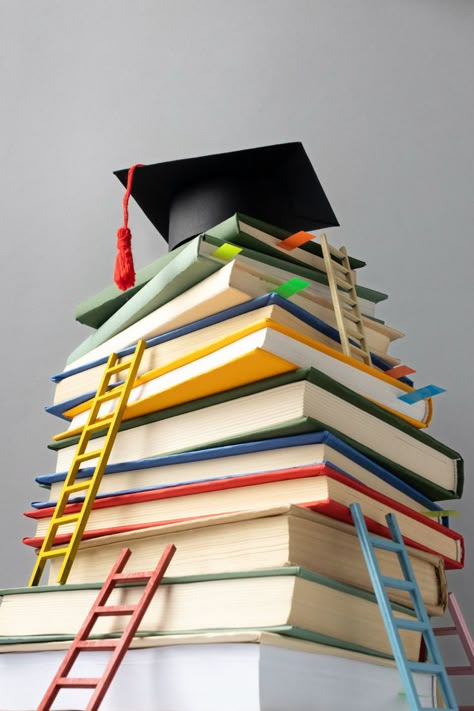 Free Photo | Low angle of stacked books, a graduation cap and ladders for education day Book Images Pictures, Back To School Promotion, Last Day Of High School, Banners Background, Education Aesthetic, School Promotion, Law Education, Education Background, Educational Background