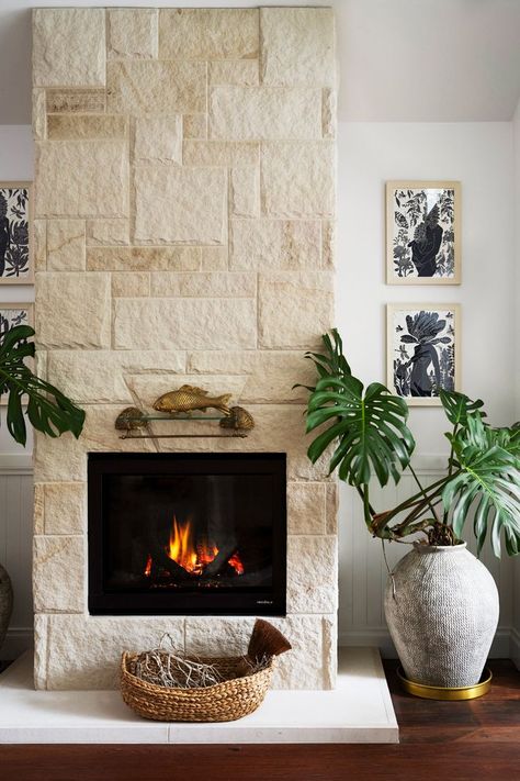 This living area is warmed by a gas fireplace surrounded by sandstone above newly stained American oak floors. A healthy monster plant sits in a nearby urn. Beachside Cottage, Cottages Interiors, Stone Fireplace Wall, Sandstone Fireplace, Cosy Fireplace, Coastal Luxe, Farm Family, Gas Fireplaces, Small Cottages