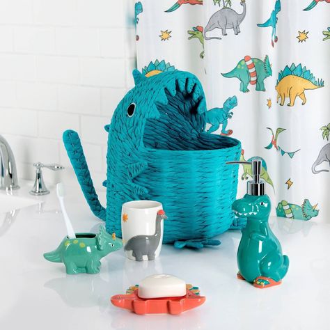 Transform your child's bathroom into a prehistoric playground with the Dinosaur 3Pc Bath Accessory Set by Allure Home Creation. The set includes a Lotion Pump with a Plastic Chrome Finish Pump Head, Toothbrush Holder and Soap Dish. Each piece is made of ceramic, creatively shaped and painted in a vibrant medley of glossy bright colors. This whimsical collection brings together a cool group of dino-mite buddies that are sure to bring fun and adventure to your little dinosaur enthusiast's bathroom Dino Nursery Ideas, Dinosaur Bathroom Decor, Toddler Bathroom Ideas, Dinosaur Toothbrush Holder, Colorful Kids Bathroom, Dinosaur Theme Room, Dinosaur Bathroom, Dinosaur Towel, Whimsical Nursery Decor