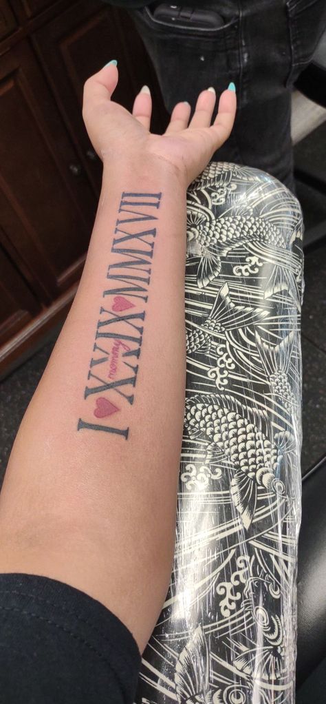 Red And Black Roman Numeral Tattoo, Roman Numeral Tattoo Inner Arm, Roman Numeral Tattoo On Arm, Numeral Number Tattoo, Inner Bicep Tattoo Women, Arm Tattoos For Women Forearm, Bicep Tattoo Women, Cute Thigh Tattoos, Roman Numeral Tattoo