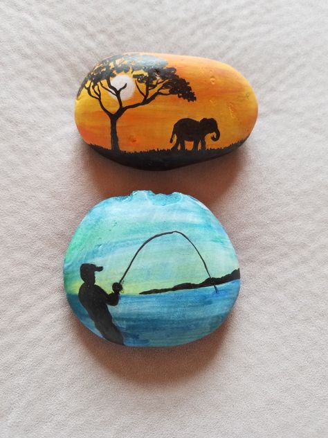 Elephant and Fishing painted rocks Fishing Rock Art, Fishing Rock Painting, Desert Painted Rocks, Fishing Rock Painting Ideas, Painted Rocks Around Campfire, Fishing Painted Rocks, Painted Rocks Fish, Painted Rocks Fish Easy, Fishing Rocks Painted Stones