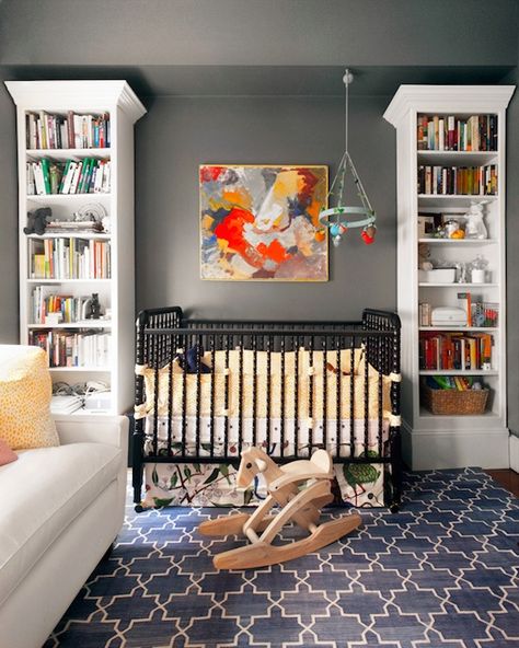 Gorgeous boy's nursery design with gray walls paint color, Madeline Weinrib Indigo Brooke Rug, Dream On Me Jenny Lind Classic Crib - Black, Blabla Multi-Birds Mobile, white bookcases and abstract painting art. Nursery Grey, Boy Nurseries, Nursery Rooms, Baby Boy Room Nursery, Nursery Modern, Real Estat, Nursery Room Boy, Grey Nursery, In The Corner