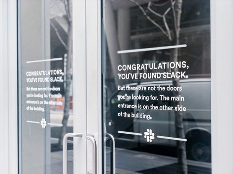 Matte white vinyl wayfinding sign with white text on glass doors for the San Francisco office of Slack, an American cloud-based set of proprietary team collaboration tools and services. Glass Door Signage, Vinyl On Glass, Glass Signage, Glass Door Design, Door Signage, Team Collaboration, Wayfinding Signs, Wall Signage, Entrance Sign