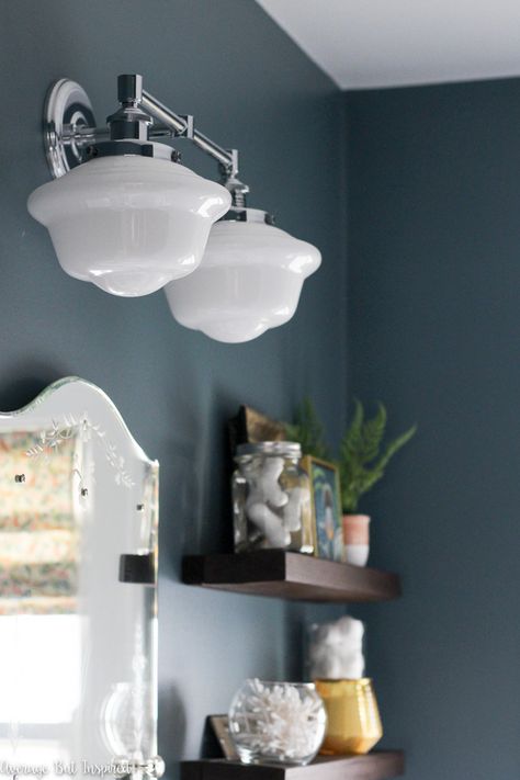 This vintage look milk glass schoolhouse bathroom vanity light paired with moody blue paint (Charlotte Slate by Benjamin Moore) make a beautiful statement in a small bathroom. #bathroomlighting #vanitylights #darkbluepaint Bathroom Sconces Double Vanity Above Mirror, Milk Glass Bathroom Vanity Light, Schoolhouse Vanity Light Bathroom, 1920s Bathroom Lighting, Schoolhouse Bathroom Light, Schoolhouse Vanity Light, Bungalow Bathroom Ideas, 1920 Bathroom 1920s Style, Slate Blue Bathroom