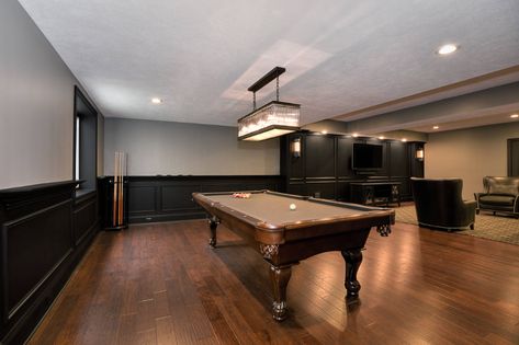 Dark Wainscoting Basement, Two Tone Basement Walls Paint Ideas, Green And Black Basement, Black Trim Basement, Basement With Black Trim, Black And Brown Basement Ideas, Wood Trim Basement, Black Wall Basement, Basement Bar Black