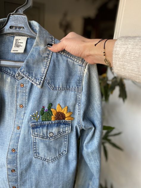 Cactus and sunflower embroidered on denim shirt Cactus And Sunflower, Embroidery Cactus, Denim Jacket Embroidery, Embroidery Jeans Jacket, Jean Diy, Embroidery Jeans Diy, Embroidered Denim Shirt, Diy Denim Jacket, Clothes Embroidery Diy