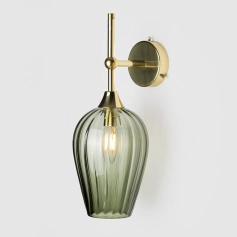 These wall sconces combine a coloured glass shade with a decorative angled metal top. The sleek elongated form pays homage to Mid Century lighting design.  Lead time 6-8 weeks. As standard, this item comes with an E14 Candle Bulb.