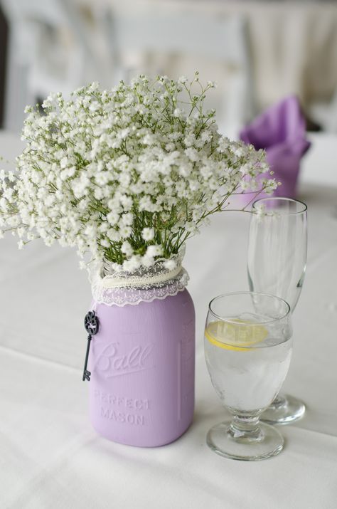 A simple bunch of babies breath in a lavender painted mason jar. Mason Jars With Lavender Flowers, Lilac Mason Jar Centerpieces, Lavender Birthday Party Ideas Simple, Lavender Mason Jar Centerpiece, Lavender Butterfly Baby Shower Ideas, Lilac Bridal Shower Ideas, Lilac Baby Shower Ideas, Lavender Bridal Shower Ideas, Lavender Baby Shower Ideas