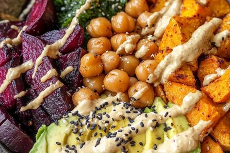 Enjoy a wholesome roasted beet and sweet potato Buddha bowl with avocado, chickpeas, and lemon-tahini dressing. Perfect for a healthy and balanced meal! Roasted Beet And Sweet Potato Budda Bowl, Beet Buddha Bowl, Sweet Potato Buddha Bowl, Potato Buddha Bowl, Avocado Rice, Chickpeas Recipe, Buddha Bowls Recipe, Lemon Tahini Dressing, Chicken Sweet Potato