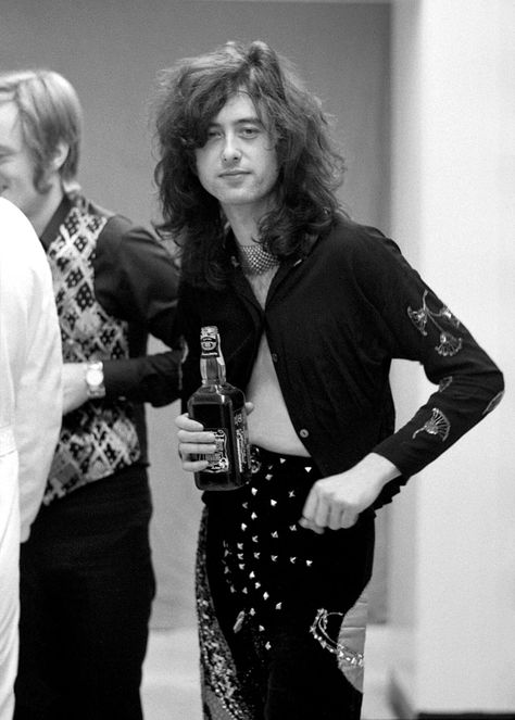 Guitarist Jimmy Page drinks whiskey backstage at Olympia Stadium in Detroit, Michigan on January 31, 1975. Led Zeppelin Live, Don King, Patrick Page, Robert Plant Led Zeppelin, The Yardbirds, John Paul Jones, John Bonham, Greatest Rock Bands, Led Zep