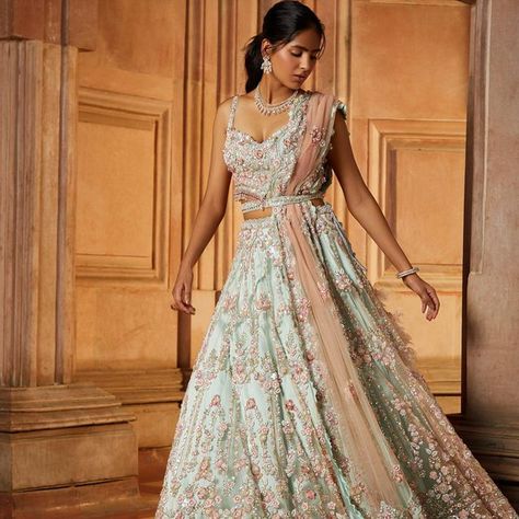 Nitika Gujral shared a post on Instagram: "This contemporary soft mint green tulle Lehenga set paired with a worked belt and a blush pink dupatta embroidered in a baroque floral pattern in tonal and contrast beads, sequins and crystals has a youthful elan! ——— Jewellery: @shriramhariramjewellers Styling and creative direction: @ayeshaaminnigam Photographer: @hormisantonytharakan HMU: @makeupkomal @aamirkhan_hairstylist Videographer: @studio36 Models: @husnbano6 Assistant stylist: @... Sage Green And Pink Lehenga, Sage Green Mehndi Outfit, Sage Lengha, Sage Green Wedding Dress For Bride, Sage Green Indian Outfit, Sage Green Lengha, Family Wedding Outfits, Pink And Green Lehenga, Crystal Lehenga