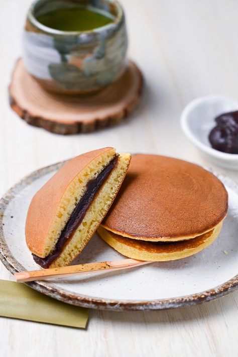 Dorayaki! Delicious red bean anko paste sandwiched between two honey flavored pancakes. This sweet is a family favorite and well loved all over Japan! You can get experimental with the fillings too, we’ve got some ideas on our website so check it out! #japanesefood #japanesecooking #japaneserecipe #anko #redbean #redbeanpaste #dorayaki #japanesepancake #pancake #japanesesweets #japaneseconfectionery #sweets #desserts #recipeblog #foodblogger #tasty #sweet #foodphotography #recipe Sudachi Recipes, Wagashi Recipe, Dorayaki Recipe, Bean Pancakes, Honey Pancakes, Japanese Dessert Recipes, Sweet Red Bean Paste, Flavored Pancakes, Japanese Wagashi