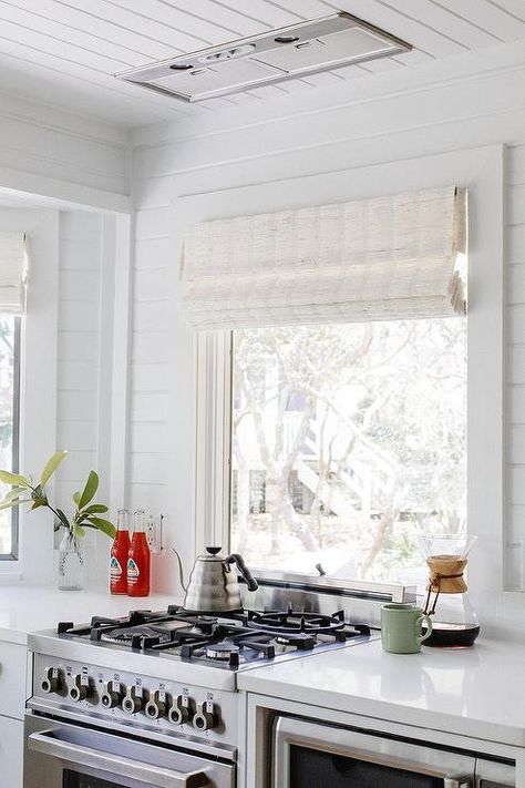 Small cottage kitchen design with a picture window over a stove and white quartz countertops. Stove Under Window In Kitchen, Corner Stove, Kitchen Cottage, Small Stove, Cottage Kitchen Design, Small Cottage Kitchen, Small Window, Kitchen White, Style Cottage