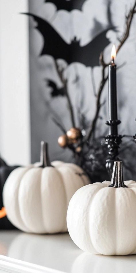 Create a hauntingly beautiful space with minimalist Halloween decor. Focus on negative space and strategic placement of a few key pieces. Display a collection of white pumpkins in varying sizes, or hang a simple wreath made of black twigs. Use lighting to cast eerie shadows, creating atmosphere without clutter. Incorporate subtle nods to Halloween with geometric ghost-shaped vases or sleek candleholders. This refined approach allows for a sophisticated celebration of the spooky season that's bot Minimalist Halloween Decor, Black White Halloween, Simple Wreath, Minimalist Halloween, Decor For Halloween, Party Styling, White Halloween, Hauntingly Beautiful, To Cast