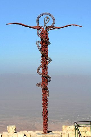 On Mt. Nebo, in the Jordanian wilderness, a Sculpture of a Bronze Serpent, testifies to the staff held by Moses and the cross of Christ where the serpent is 'crushed under foot'. Source: Google Images Moses Staff, Bronze Serpent Tattoo, Desert Tomb Fantasy Art, Moses Bronze Serpent, Moses And The Burning Bush Art, Jordan Tattoo, Adventure Tattoo, Petra Jordan, The Cross Of Christ