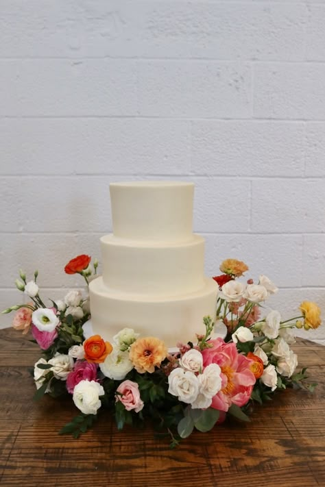 Cake Surrounded By Flowers, Floral 3 Tier Wedding Cake, Plain White Wedding Cake With Flowers, Wedding Cake Surrounded By Flowers, Wedding Cake With Flowers Around Base, Flowers Around Wedding Cake, Cake Table Florals, Simple 3 Tier Wedding Cake, Tres Leches Wedding Cake