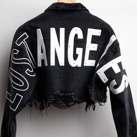 Cropped Distressed Denim Jacket Features Wide Back Patches With The Letters Wording "Lost Angeles" (Light Rhinestone On Letters) Distress Hemline, Long Sleeves, Collar, Front Button Down And Chest Pockets. (Please Note That All Of Our Products Are Hand Made And Include Hand Work So Depending On The Number Of Units Your Order Might Take 1-2 Days To Complete You Will Receive An Email Or Call For Completed Order) 78% Cotton 15% Rayon 7% Polyester Made In China Denim Jacket Personalized, Streetwear Fashion Women Winter, Denim Leather Jacket, Denim Jacket Black, Crop Denim Jacket, Crystal Makeup, Embroidered Jean Jacket, Loft Ideas, Oversized Jean Jacket