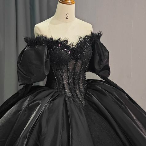 This luxurious black party ball gown boasts a dazzling beaded corset-style bodice adorned with delicate lace and topped with puffy off-the-shoulder sleeves. The princess waist and full ball gown skirt, complete with a train, create a regal silhouette. The ribbon lace-up back adds a touch of sophistication and allows for a customized fit. a line ball gown style: formals color as shown built in bra sweetheart neckline train as shown lace up back Quncie Dresses Black, Princess Dress Black, Ballroom Extravaganza, Princess Quinceanera Dresses, Fairytale Wedding Gown, Black Quince, Beaded Corset, Plus Size Evening Gown, Gothic Princess