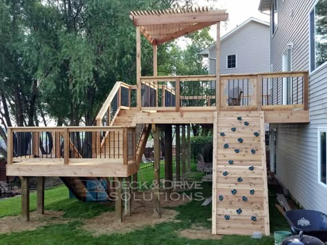 New Cedar Deck with Slide and Rock Wall | Deck and Drive Solutions Deck With Slide, Garden Rock Wall, Vinyl Decking, Ideas Terraza, Outdoor Architecture, Laying Decking, Cedar Deck, Under Deck, Deck Construction