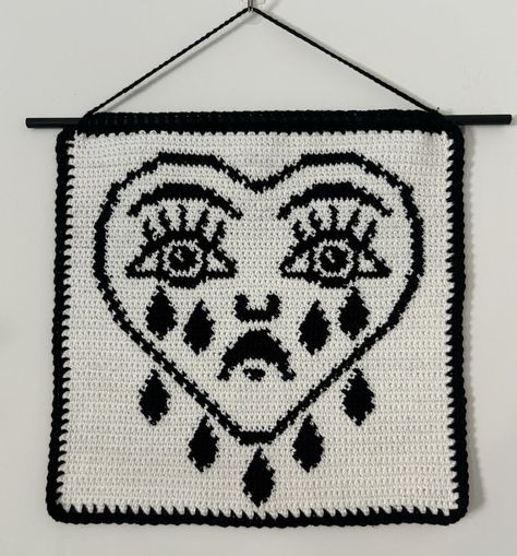 ~THIS IS A DIGITAL CROCHET PATTERN - INSTANT DOWNLOAD~ THIS IS FOR A PATTERN ONLY THIS IS NOT A FINISHED PRODUCT --------------------------------------------- 🧶 Crying Heart Wall Hanging Crochet Pattern - Digital Download 😢❤️ 📥 Instantly download this PDF document containing step-by-step instructions and some pictures to create your very own Crying Heart Wall Hanging. 🌍 Language: English (US terminology) 🧵 Skill Level: Beginner - Basic stitches required: single crochet, chain stitch ✨ Mater Crocheted Wall Hangings, Tapestry Bedroom Crochet, Alternative Crochet Patterns Free, Crochet Room Decor Free Pattern, Single Skein Crochet Projects, Grid Crochet Patterns 30x30, Phoebe Bridgers Tapestry Crochet, Crochet Skull Wall Hanging, Crochet Wall Hanging Alpha Pattern