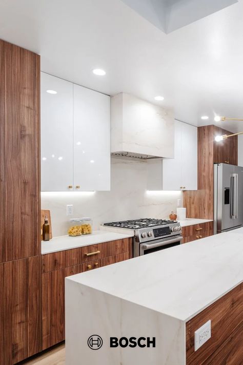 The Bosch fridge and range look at home with the high gloss white and walnut cabinets in this modern kitchen by @markahermogeno. The skylights are a bonus too! Thanks so much for sharing your work. Photo Credit: Neue Focus. Cabinets: NGY Group Inc. Countertops + Skylight: @Dekton_ . Walnut And White Kitchen, White And Walnut Kitchen, Kitchen 2025, Flat Front Cabinets, Bosch Fridge, Walnut Kitchen Cabinets, White Gloss Kitchen, Top Kitchen Cabinets, Gloss Kitchen