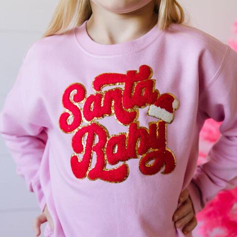 The Santa Baby Patch Christmas Sweatshirt is a fun and festive sweatshirt for celebrating Christmas! Crewneck Color: Pink, Patch Color: Red and white chenille with gold glitter outline. Features: Tagless inside neck label for an itch-free wear; cozy fleece lining. Fit: Toddler Unisex; True to Size. Each sweatshirt is hand pressed with love in our hometown warehouse. | Sweet Wink | Santa Baby Patch Christmas Sweatshirt, (Pink, Size 2Y) | Maisonette collects the best children’s products from aroun Christmas Tutu, Pink Patch, Trendy Shirt Designs, Celebrating Christmas, Holiday Sweatshirt, Neck Label, Santa Baby, Pink Sweatshirt, Shop Sweatshirts