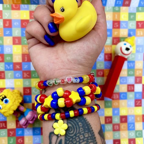 Handmade primary color clown theme Kandi bracelet cuff set of 3  With alphabet beads "clown" and yellow flower charm  *clown letter beads and charms may differ slightly * One size fits most ( approximately 6-7 in) Tags; clown clowncore kandicore clown town kidcore rave accessories jewelry Y2K weird weirdcore Clowncore Kandi Bracelets, Clown Bracelet, Clowncore Kandi, Clown Kandi, Kandi Accessories, Pony Beads Bracelet, Kidcore Accessories, Kandi Charms, Clown Theme