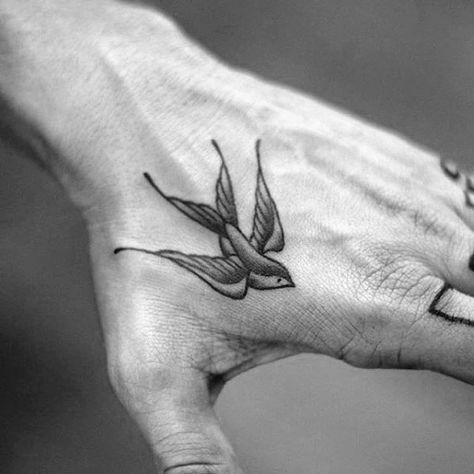 Old School Swallow Mens Traditional Hand Tattoo Inspiration Men Swallow Tattoo, Hand Sparrow Tattoo, Swallow Tattoo Hand Men, Manly Hand Tattoos, Small Men’s Hand Tattoo, Small Swallow Tattoo Men, Swallow Tattoo On Hand, Swallow Tattoo Design For Men, Bird On Hand Tattoo