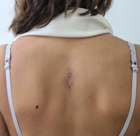 Small Dainty Unique Tattoos, Tulip Back Tattoo Women, Spine Tattoos For Women Tulips, Tulips Back Tattoo, Tulip Back Tattoo, Tulip Spine Tattoo, Tulip Fine Line Tattoo, Tiny Back Tattoos For Women, Small Spine Tattoos For Women