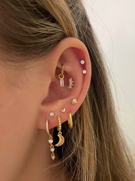 stacked lobes, rook with hoop and charm, double helix and high conch Staggered Ear Piercings, Triangle Lobe Piercing Triple, Constellation Piercing Lobe, Cute Stacked Earrings, Cute Gold Ear Piercings, Stack Piercing Lobe, Double Helix With Conch, Stacked Love Ear Piercings, Multiple Earlobe Piercings