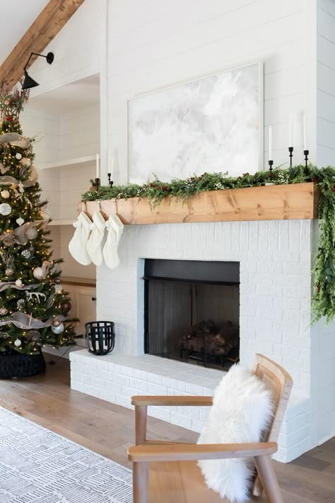 Two Story White Brick Fireplace, White Brick Fireplace With Wood Mantle Built Ins, Tall White Brick Fireplace, 2023 Brick Fireplace Trends, White Brick And Wood Fireplace, White Brick Fireplace Christmas Decor, White Chimney Fireplaces, Brick Electric Fireplace Ideas, White Brick Electric Fireplace