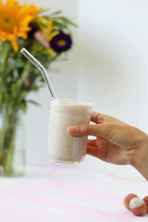 Hand holding a glass jar with a light pink lychee smoothie and a glass straw in it. Lychee Smoothie, Lychee Recipes, Chia Drink, Infused Waters, Milk Syrup, Infused Water, Desert Recipes, Kefir, Cocktail Recipes